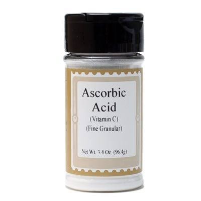 A bottle labeled Ascorbic Acid (Vitamin C), a dough-strengthening ingredient used in small amounts in bread baking