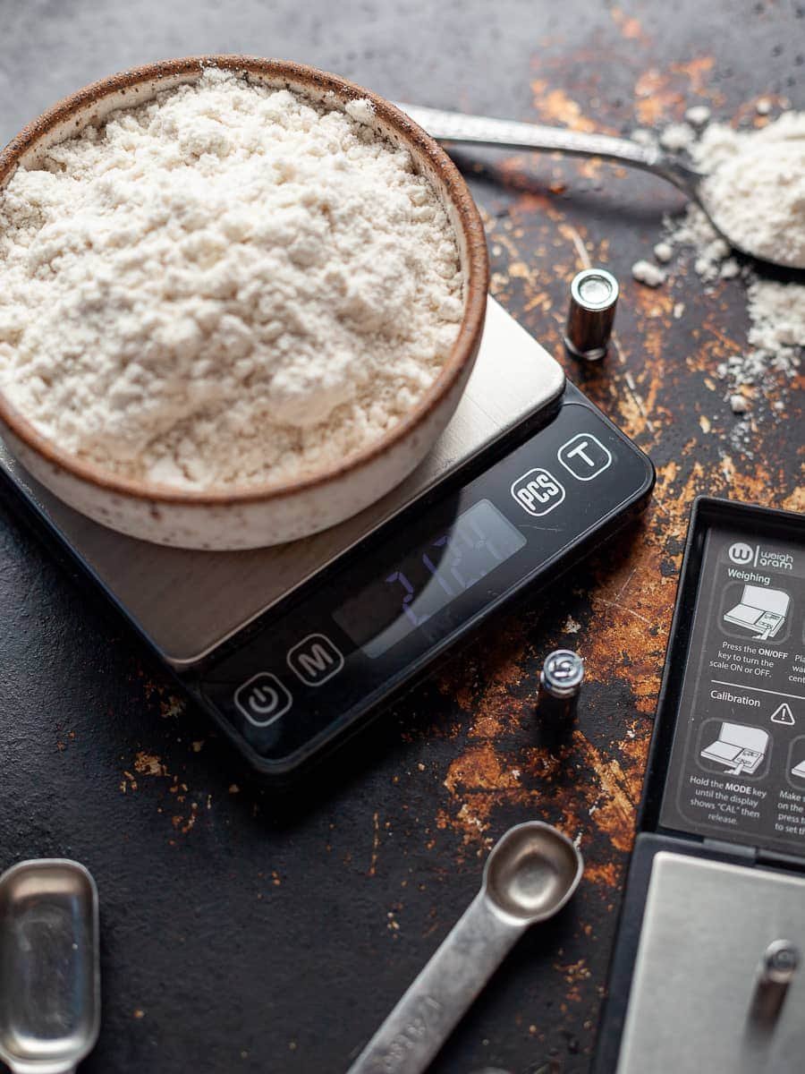 Baker's Percentage: kitchen scale with flour and water, simple weights visible