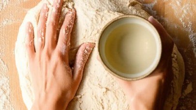 Bassinage: held-back water being worked into dough
